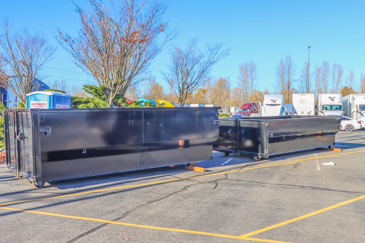 Professional dumpster rental service with roll-off container on residential driveway in Fort Stockton
